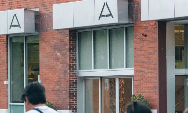 Exterior building image with modern signage above the windows that says M-A-A-A.