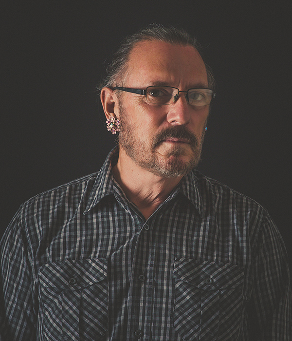 Man with glasses sitting for a portrait