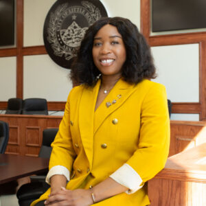 Portrait of Melissa Mitchell wearing a yellow blazer.